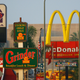 Signs for Taco Bell, Grinder, McDonalds, Panda Express fast-food restaurant line the streets in the Figueroa Corridor area of South Los Angeles on July 24, 2008, Los Angeles, California.